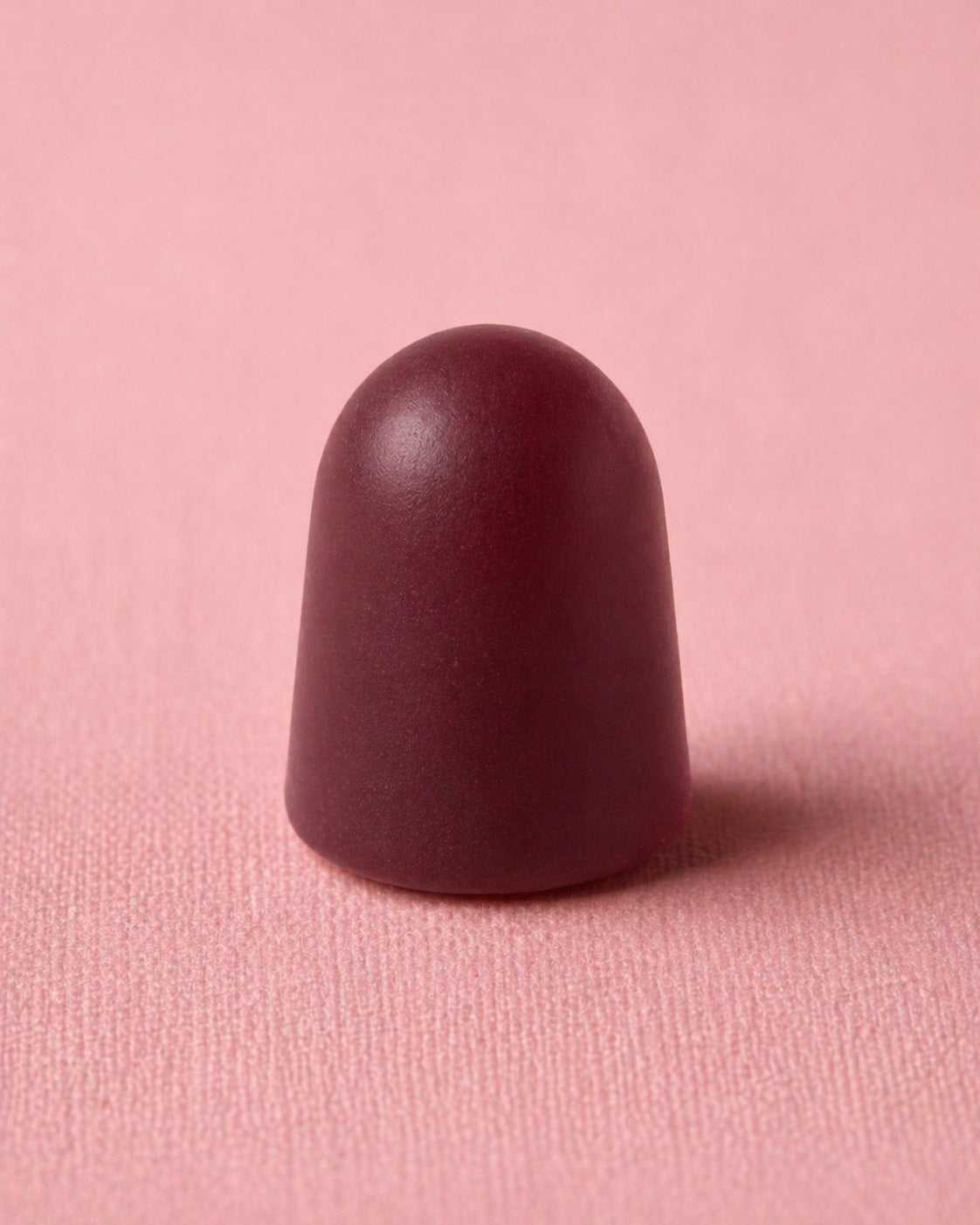 Maroon GUMMY on a pink background