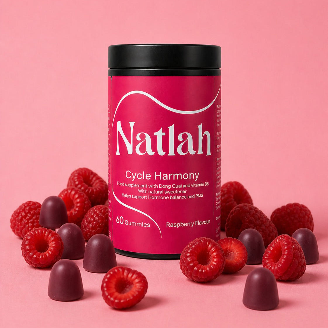 Natlah Cycle Harmony gummies with raspberries on a pink background